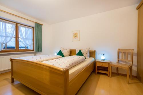 a small bedroom with a wooden bed and a window at Ferienwohnung Kühn in Oberstdorf