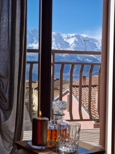 a candle on a table with a view of mountains at TraMonti Apartments in Poggio Picenze