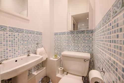 a bathroom with a white toilet and a sink at Pelican Cottage, Aldeburgh in Aldeburgh