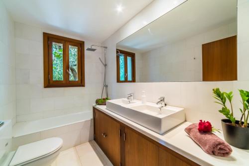 カンパネにあるIdeal Property Mallorca - Sa Velaのバスルーム(洗面台、トイレ、鏡付)
