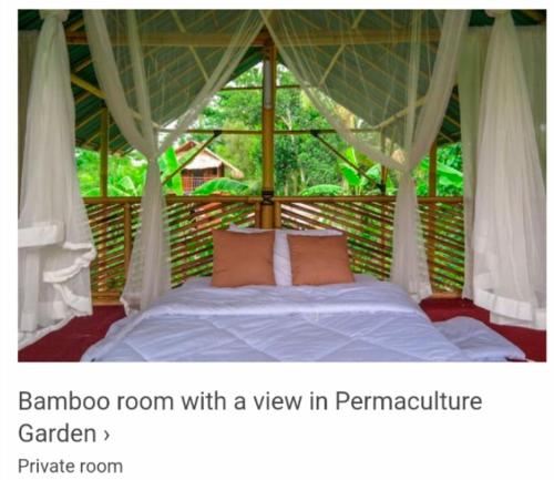 a bedroom with a bed with a view in a tent at Ancut Garden in Ubud