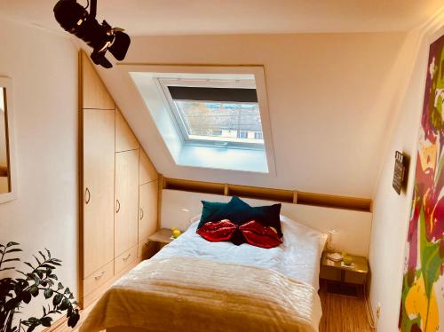 a bedroom with a bed with a window on it at SLEEP INN Bed&Breakfast in Amblève