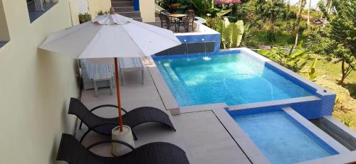 an overhead view of a swimming pool with an umbrella at An Pao Beach Residence Villa 1 - Koh Yao Noi in Ko Yao Noi