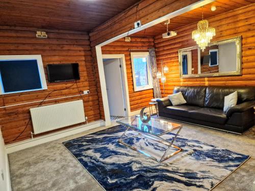 a living room with a couch and a glass table at Kaoglen Warren - Pet friendly - Hot Tub - Cairngorms in Blairgowrie