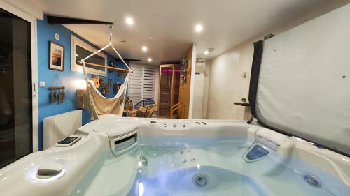 a large bath tub in a room with at Les pieds dans l'eau... au chaud !!! in Le Crotoy