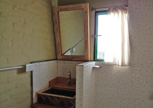 a bathroom with a mirror and a sink at El Atelier - Valle de Uco in La Consulta