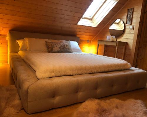 a bedroom with a bed in a wooden room at Chalet Holmen in Uddevalla