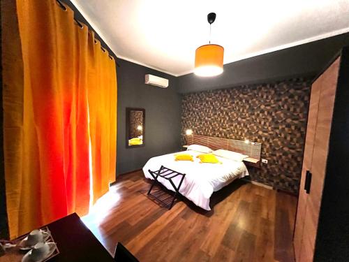 a bedroom with a bed with yellow pillows on it at Prati Comfort in Rome