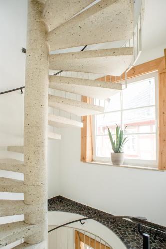 a staircase in a house with a stone wall at Designapartment im Herzen der Altstadt - 7 Guests - 3 Bedrooms - 2 Bathrooms in Limburg an der Lahn
