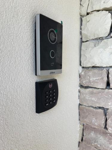 a remote control on a wall with a stone wall at Villa Vrachos luxury Living in Vrachos