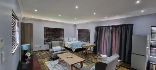 a living room with a bed and a table at Studio View in Northwold