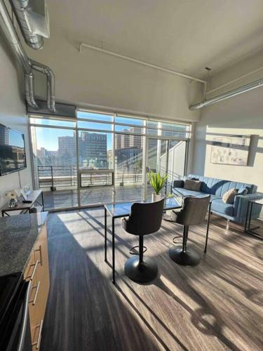 a large living room with a glass table and chairs at Apt Downtown Detroit with VIEW in Detroit