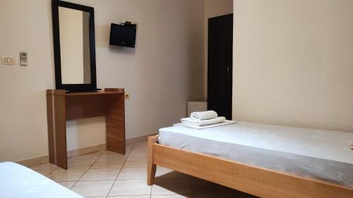 a room with two beds and a mirror and a sink at Guesthouse Villa Joanna&Mattheo in Sarandë
