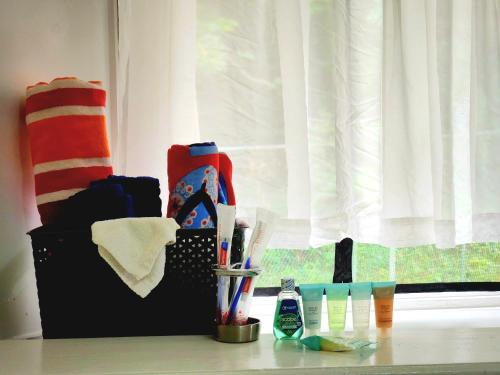a counter with toothbrushes and other items on a window at Relax on the Ridge - Ocho Rios Escape in Ocho Rios