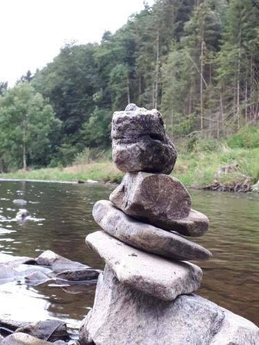 a stack of rocks sitting on top of a river at SLEEP INN Bed&Breakfast in Amblève