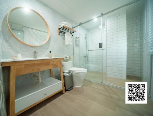 La salle de bains est pourvue d'un lavabo, d'un miroir et de toilettes. dans l'établissement 虎尾小9窩, à Huwei