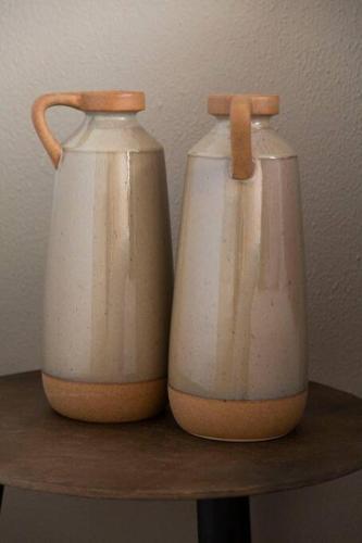 two white vases sitting on top of a shelf at Shangri-la Doonside in Kingsburgh