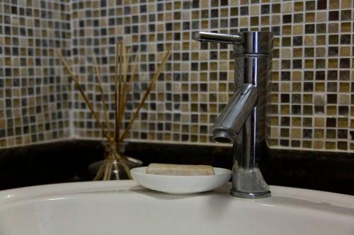 a sink with a faucet and a bowl on a tub at Shangri-la Doonside in Kingsburgh