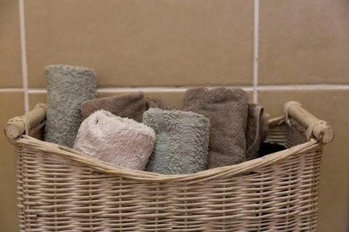 a basket filled with towels in a bathroom at Shangri-la Doonside in Kingsburgh