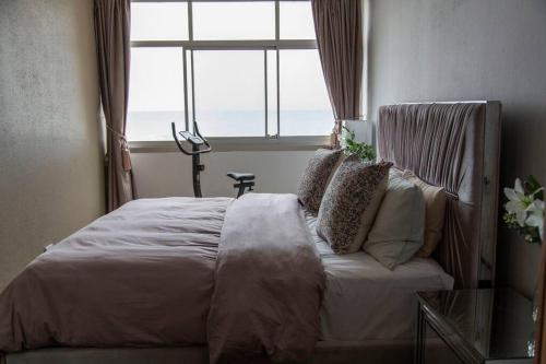 a bedroom with a large bed with a window at Shangri-la Doonside in Kingsburgh