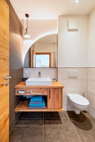 a bathroom with a sink and a toilet at Landhotel zum Wagen in Achern