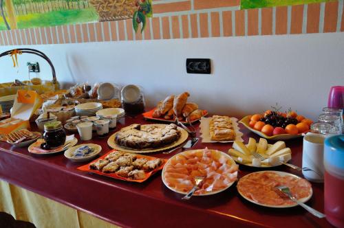 a table topped with lots of different types of food at Agriturismo ai Ciliegi in Bardolino