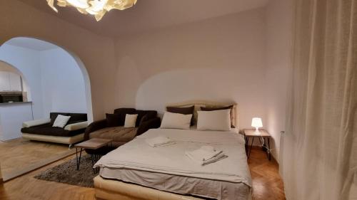 a bedroom with a bed and a living room at Apartments near Belgrade Waterfront in Belgrade