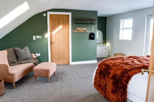 a bedroom with a bed and a chair and a door at Liberty Redcar in Redcar