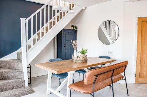a dining room with a wooden table and blue chairs at Liberty Redcar in Redcar