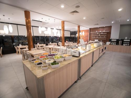 a buffet line with food in a restaurant at Hotel New Skanpol in Kołobrzeg