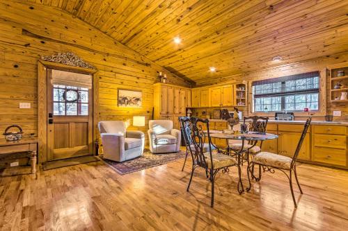 a kitchen and dining room with a table and chairs at Pet-Friendly Cabot Cabin with Fenced Yard! in Cabot