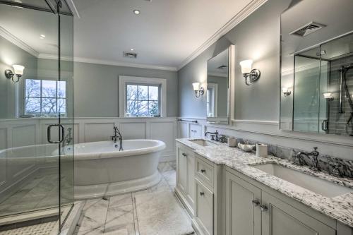 a bathroom with two sinks and a tub and a shower at Shelter Island Retreat with Outdoor Pool! in Shelter Island