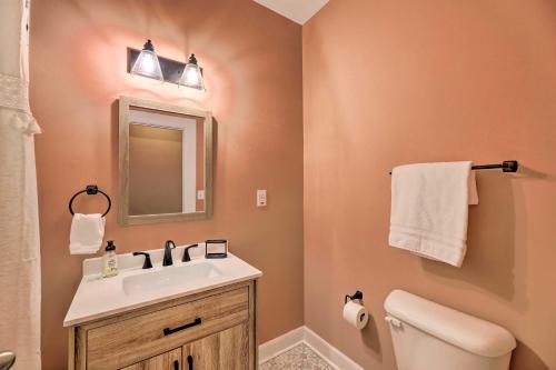 a bathroom with a sink and a toilet and a mirror at Near Downtown Dayton Historic South Park Home in Dayton