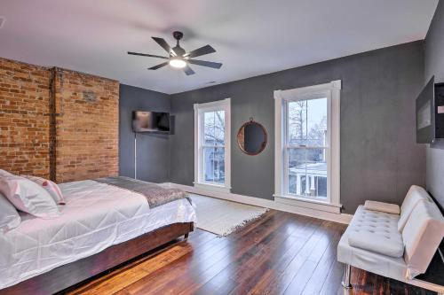 a bedroom with a bed and a brick wall at Near Downtown Dayton Historic South Park Home in Dayton
