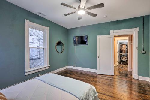 a bedroom with green walls and a ceiling fan at Near Downtown Dayton Historic South Park Home in Dayton