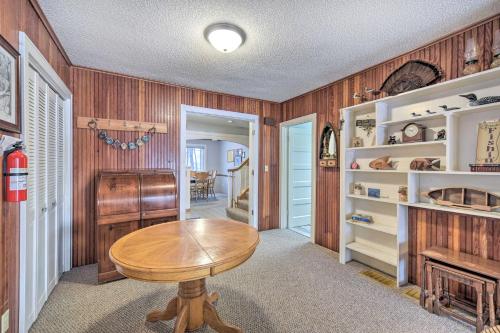 a dining room with a table and a fireplace at Spacious Home with Deck on Lake Chetek! in Chetek
