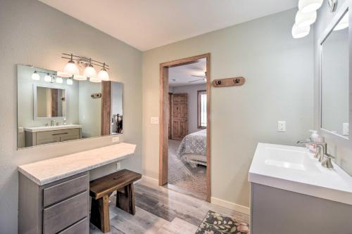 a bathroom with a sink and a mirror at Spacious Home with Deck on Lake Chetek! in Chetek