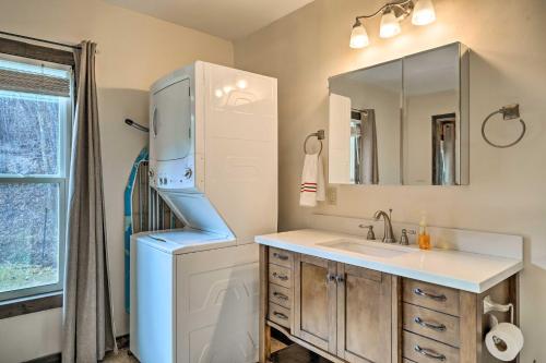 a bathroom with a sink and a refrigerator at Cozy Cottage Near Broyhill Walking Park! in Lenoir