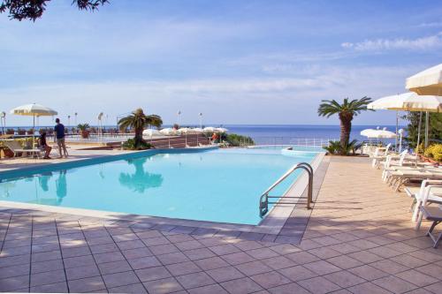 a swimming pool with a view of the ocean at Hotel Club San Diego in Maratea