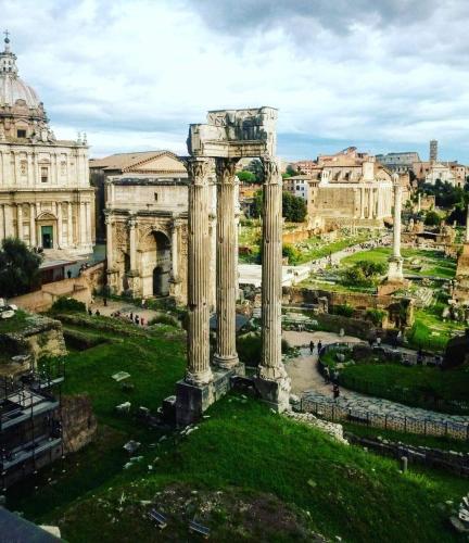 a view of the ruins of a building with columns at La Casa di Ludovica all'Appio Latino in Rome