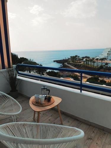 a table and chairs on a balcony with a view of the ocean at Sunset, Ocean Views 214 in Playa Paraiso