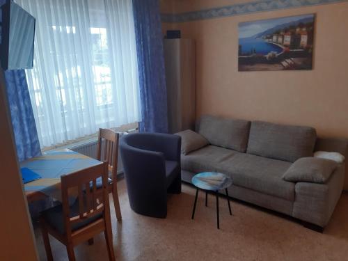 a living room with a couch and a table at Willekes Blütenhof in Madfeld