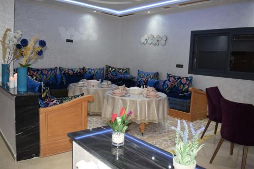 a dining room with two tables and chairs at Moonrise Villa VIP Midelt in Midelt