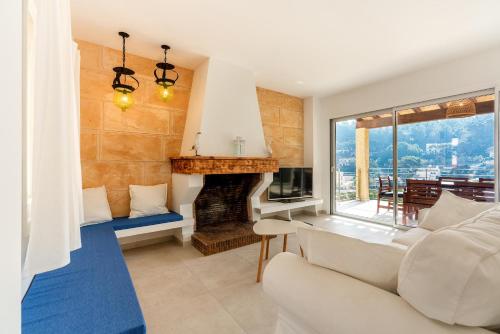 a living room with a couch and a fireplace at Lovely Central Apartment Guillem 3 Bedrooms Close To The Beach in Cala de Sant Vicent