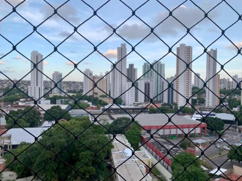 a view of a city from behind a fence at Apto moderno e bem localizado in Recife