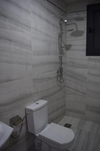 a white bathroom with a toilet and a sink at Moonrise Villa VIP Midelt in Midelt