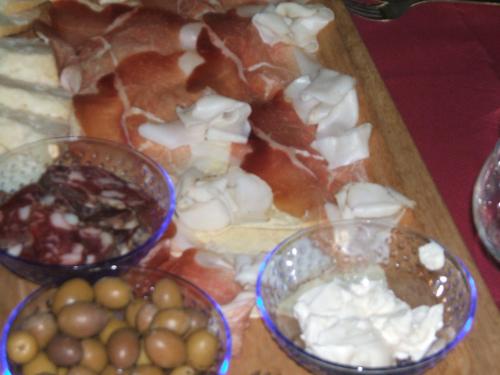 a tray of different types of food on a table at Su Ghindalu Guesthouse in Villanova Monteleone