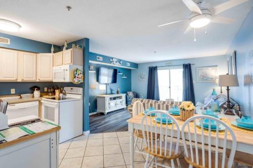 a kitchen and living room with a table and chairs at Marylander Condominiums, 90 steps from the beach in Ocean City