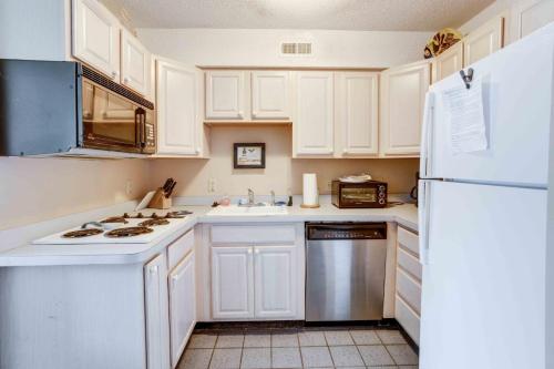 a kitchen with white cabinets and a white refrigerator at Marylander Condominiums, 90 steps from the beach in Ocean City