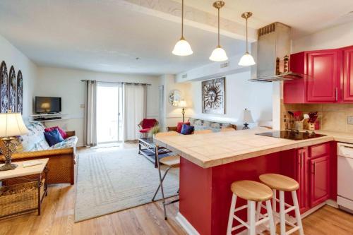 an open kitchen and living room with red cabinets at Marylander Condominiums, 90 steps from the beach in Ocean City